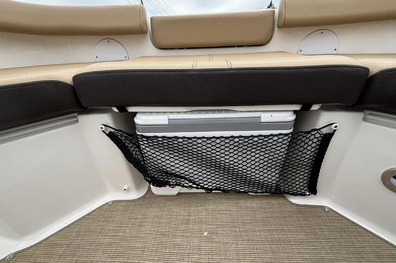 Slide: The Image of 2024 Sea Ray SDX 250 boat interior with storage net and cooler under seat. - 32