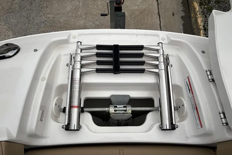 Slide: The Image of 2024 Sea Ray SDX 250 boat ladder and anchor storage compartment. - 33