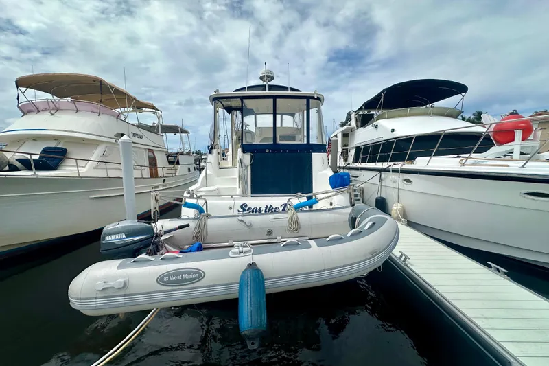 The Image of 2005 Meridian 459 Motoryacht docked with inflatable dinghy, surrounded by other boats. - 1