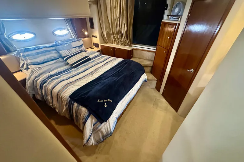 Slide: The Image of Luxurious bedroom in 2005 Meridian 459 Motoryacht with striped bedding and elegant wood finishes. - 26