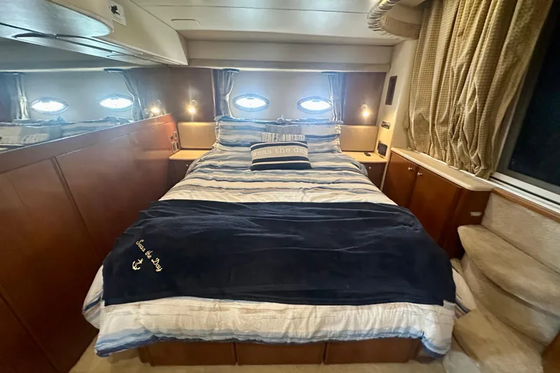 Slide: The Image of Luxurious bedroom interior of 2005 Meridian 459 Motoryacht with cozy bedding and elegant wood finishes. - 27