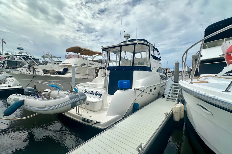 Slide: The Image of 2005 Meridian 459 Motoryacht docked at marina, surrounded by other boats. - 3