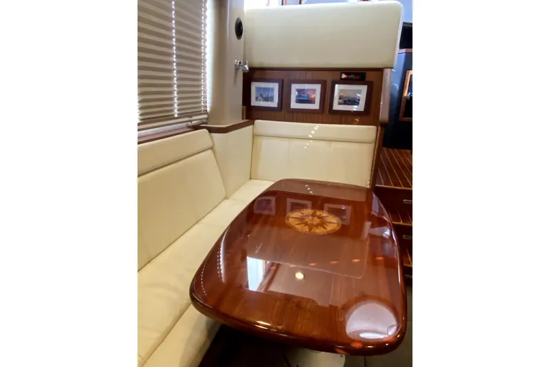 Slide: The Image of Luxurious interior of 2007 American Tug 34 with elegant wood table and cream seating. - 10