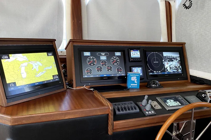 Slide: The Image of 2007 American Tug 34 helm with navigation and control displays. - 15