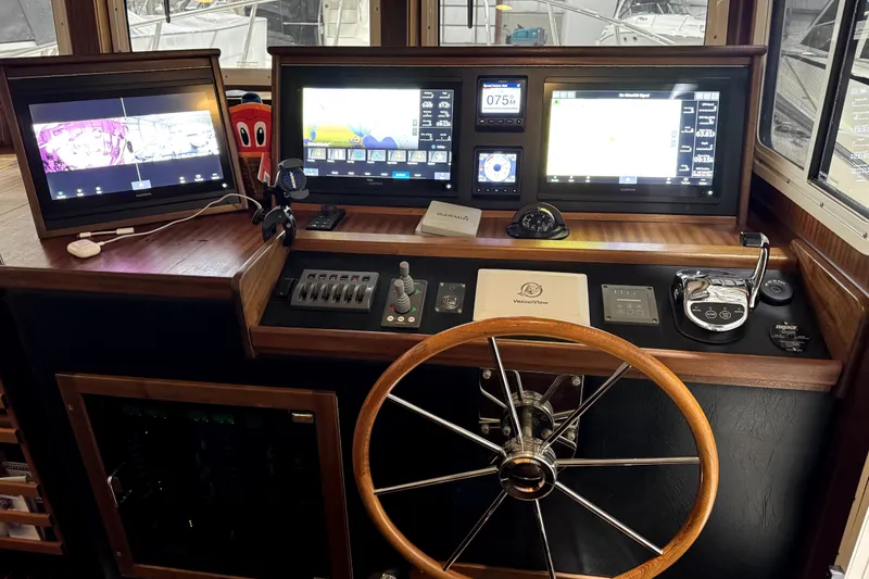 Slide: The Image of Pilothouse of 2007 American Tug 34 with navigation screens and steering wheel. - 16