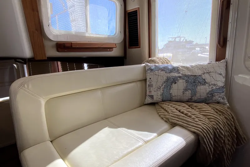 Slide: The Image of Cozy interior of 2007 American Tug 34 with map-themed pillow and soft blanket. - 20