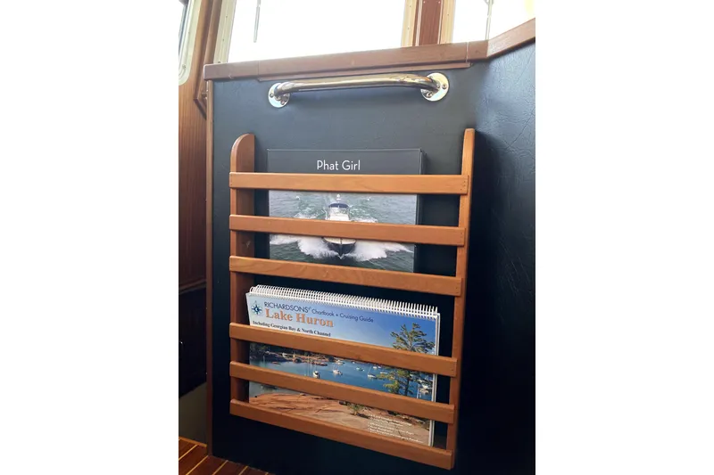 Slide: The Image of Wooden magazine rack on 2007 American Tug 34, holding boating guides and books. - 22