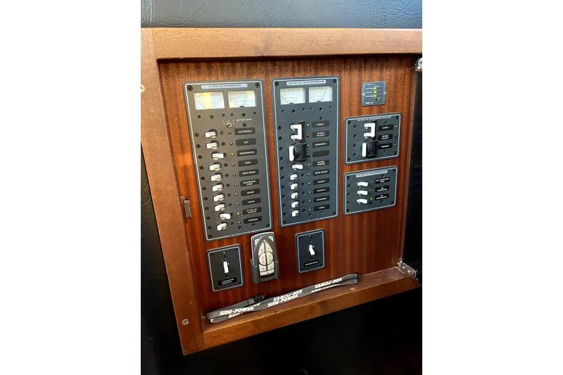 Slide: The Image of Electrical panel of a 2007 American Tug 34 boat, featuring switches and controls. - 23