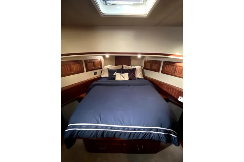 Slide: The Image of Luxurious cabin interior of 2007 American Tug 34 with cozy bedding and wooden accents. - 25