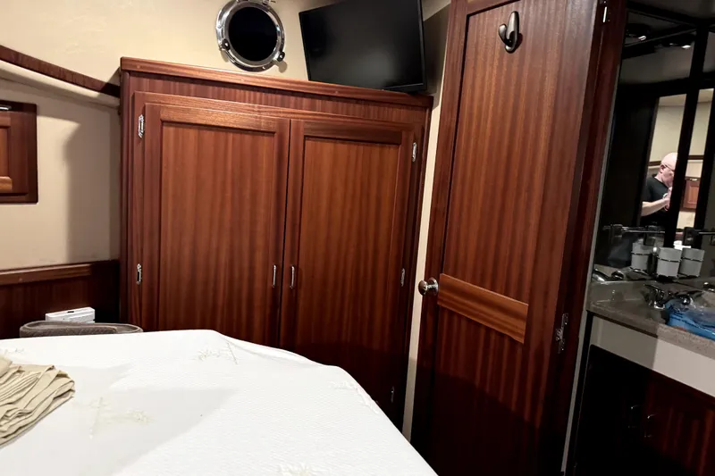 Slide: The Image of Interior of 2007 American Tug 34, featuring wood cabinetry and a cozy cabin space. - 27