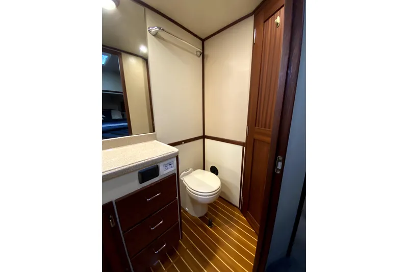 Slide: The Image of Bathroom interior of 2007 American Tug 34, featuring wood accents and modern fixtures. - 30