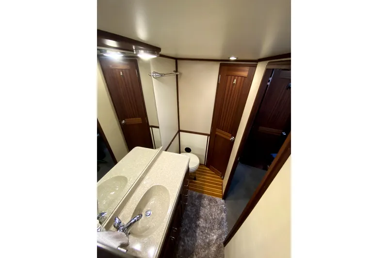Slide: The Image of Bathroom interior of 2007 American Tug 34, featuring dual sinks and wooden accents. - 31