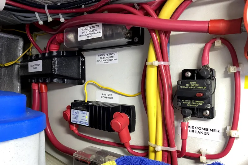 Slide: The Image of Electrical panel of a 2007 American Tug 34 with wiring and circuit breakers. - 34