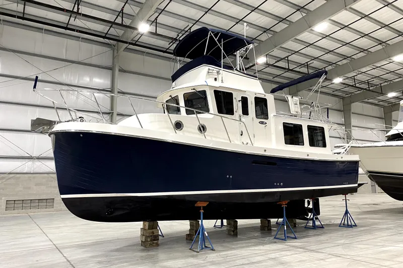 Slide: The Image of 2007 American Tug 34 boat in indoor storage, elevated on stands. - 37