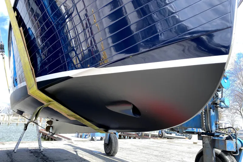 Slide: The Image of 2007 American Tug 34 boat hull on dry dock, showcasing sleek design and craftsmanship. - 39