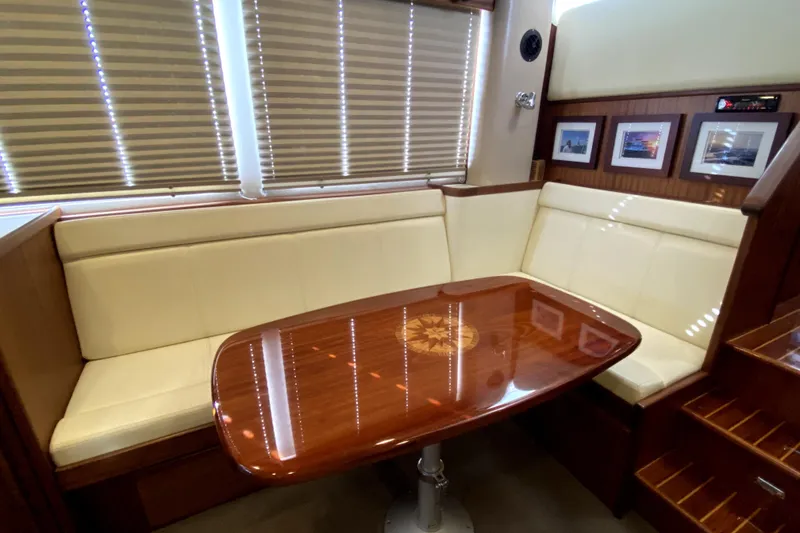 Slide: The Image of Luxurious interior of 2007 American Tug 34 with elegant wood table and cream seating. - 9