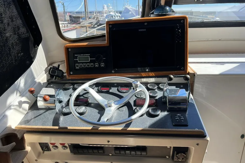 Slide: The Image of 1976 Rare HARRIS 36 EXPRESS boat helm with steering wheel and navigation controls. - 10