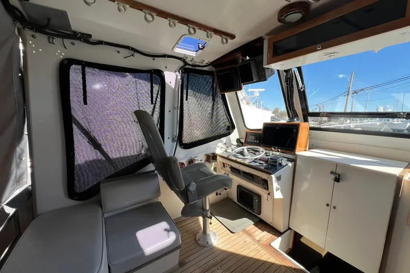 Slide: The Image of Interior of 1976 Rare HARRIS 36 EXPRESS boat with helm and seating area. - 17