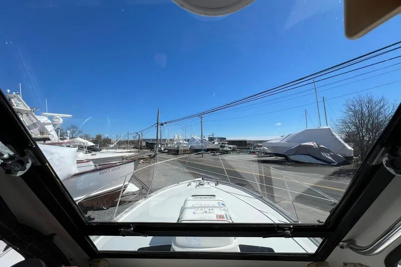 Slide: The Image of View from 1976 Rare HARRIS 36 EXPRESS boat, surrounded by other boats in storage. - 18