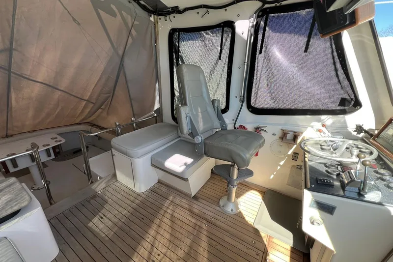 Slide: The Image of Interior of a 1976 Rare HARRIS 36 EXPRESS boat with helm and seating area. - 22