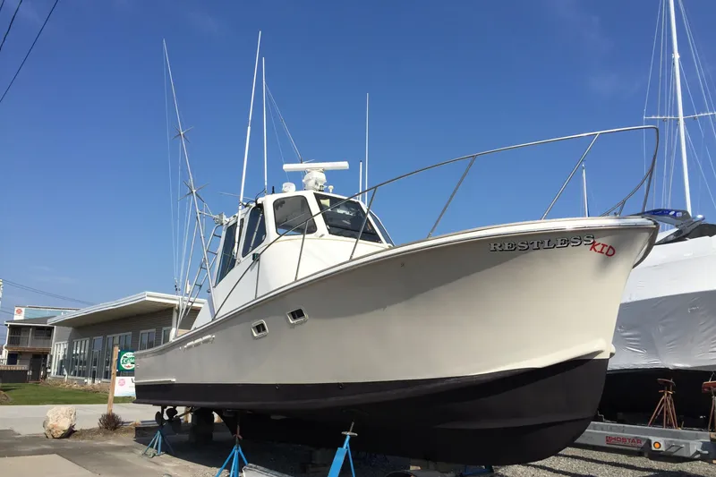 Slide: The Image of Interior of a 1976 Rare HARRIS 36 EXPRESS boat with seating and storage. - 5