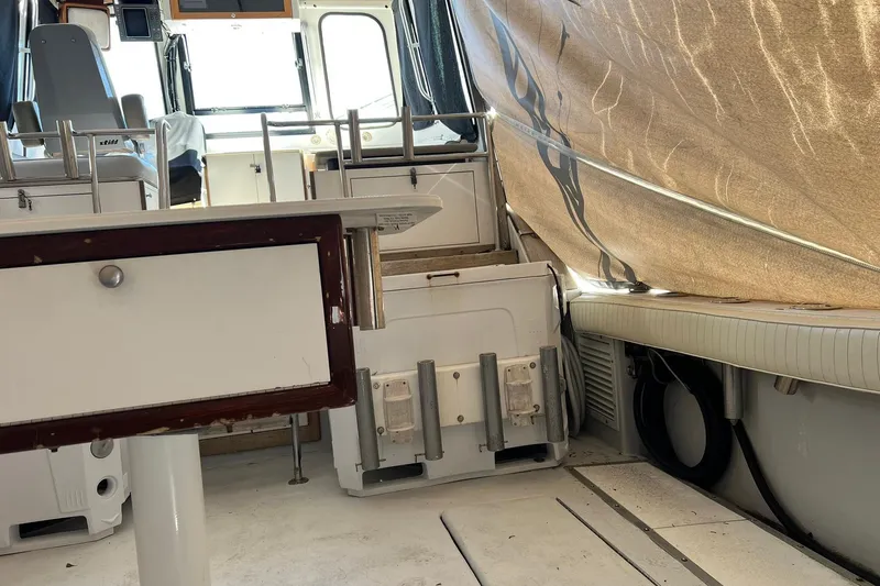 Slide: The Image of Interior of a 1976 Rare HARRIS 36 EXPRESS boat with seating and storage. - 6
