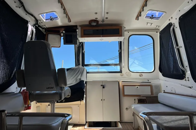 Slide: The Image of Interior of a 1976 Rare HARRIS 36 EXPRESS boat with seating and navigation area. - 8