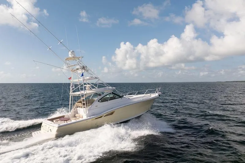 Slide: The Image of 2005 Tiara Yachts 4200 Open cruising on open water under a blue sky. - 11