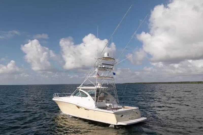 Slide: The Image of 2005 Tiara Yachts 4200 Open cruising on open water under a cloudy sky. - 12