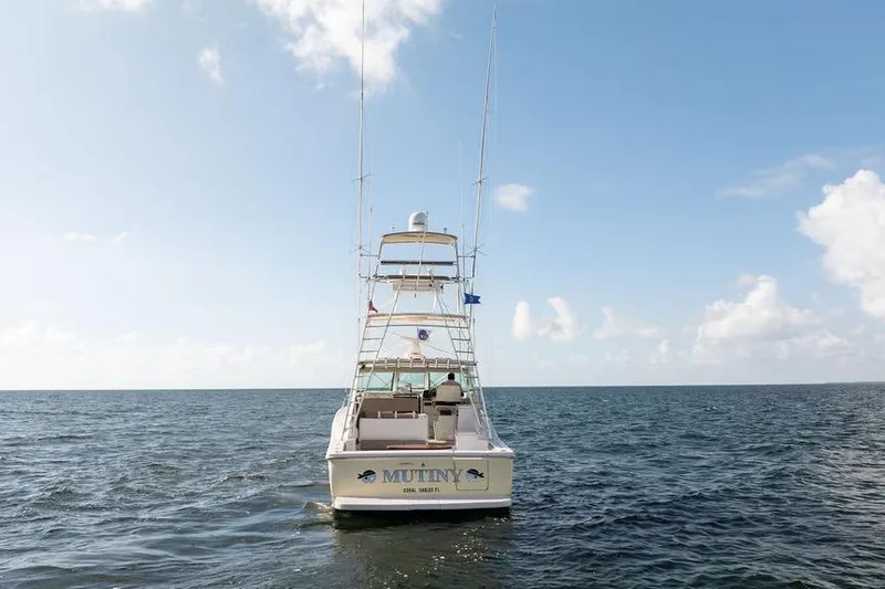 Slide: The Image of 2005 Tiara Yachts 4200 Open on open water under clear blue sky. - 13