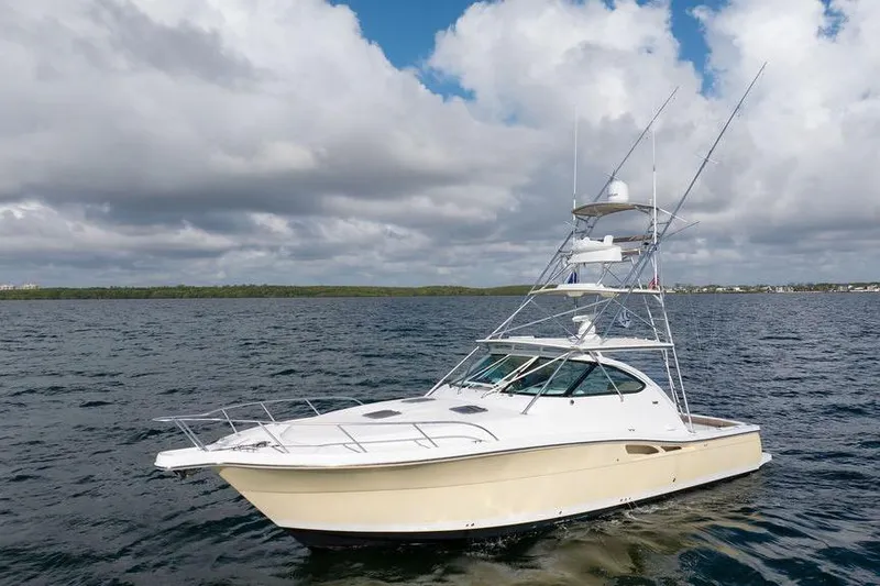 Slide: The Image of 2005 Tiara Yachts 4200 Open on calm waters under cloudy sky. - 14