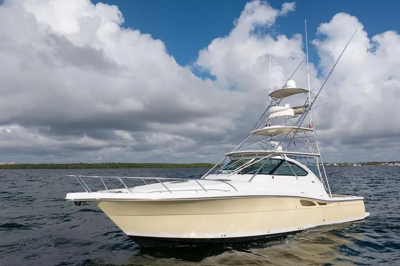 Slide: The Image of 2005 Tiara Yachts 4200 Open cruising on open water under cloudy skies. - 15