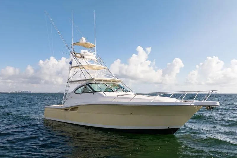 Slide: The Image of 2005 Tiara Yachts 4200 Open cruising on open water under a clear sky. - 17