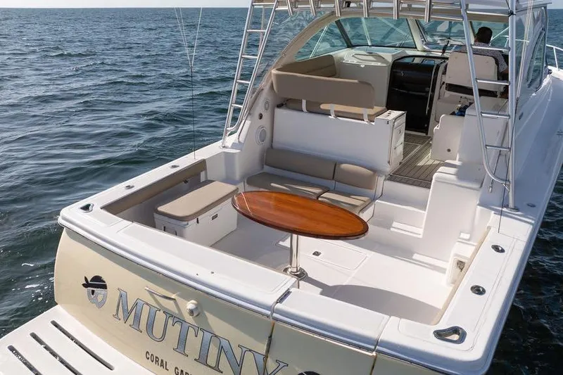 Slide: The Image of 2005 Tiara Yachts 4200 Open on water, featuring spacious deck and seating area. - 18