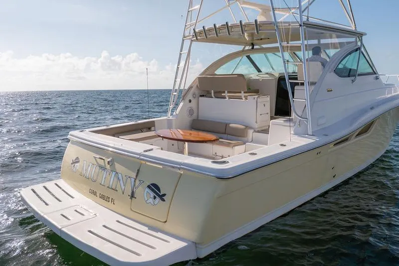 Slide: The Image of 2005 Tiara Yachts 4200 Open on water, featuring spacious deck and seating area. - 19