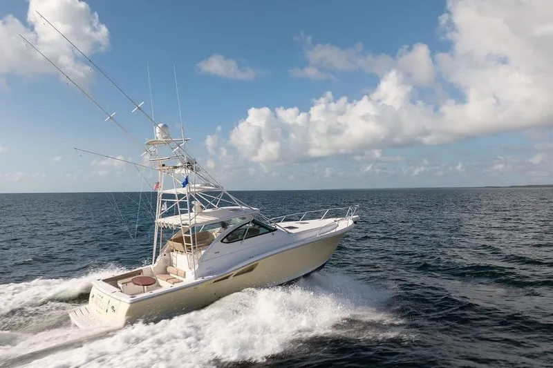 Slide: The Image of 2005 Tiara Yachts 4200 Open cruising on open sea under blue sky. - 3