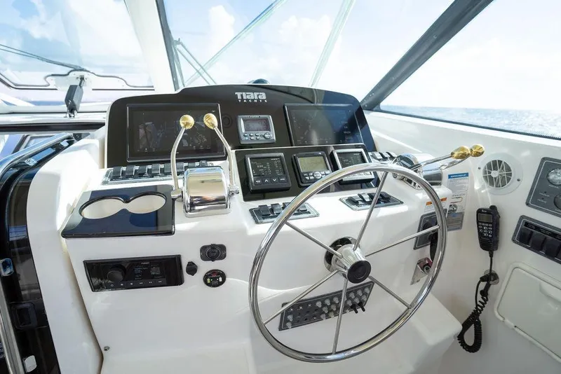 Slide: The Image of Helm of 2005 Tiara Yachts 4200 Open with steering wheel and navigation controls. - 35