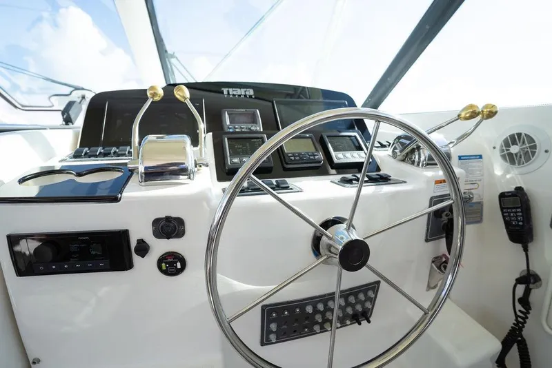 Slide: The Image of Helm of 2005 Tiara Yachts 4200 Open, featuring steering wheel and control panel. - 36