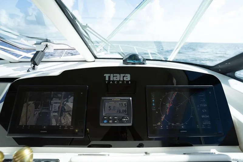 Slide: The Image of Dashboard of a 2005 Tiara Yachts 4200 Open with navigation displays. - 37