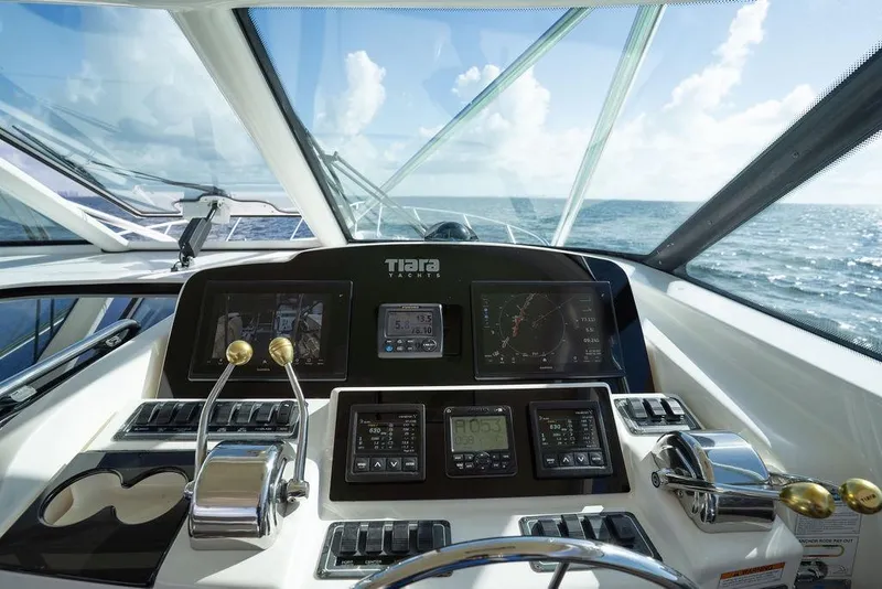 Slide: The Image of Cockpit view of 2005 Tiara Yachts 4200 Open, showcasing navigation instruments and ocean horizon. - 38