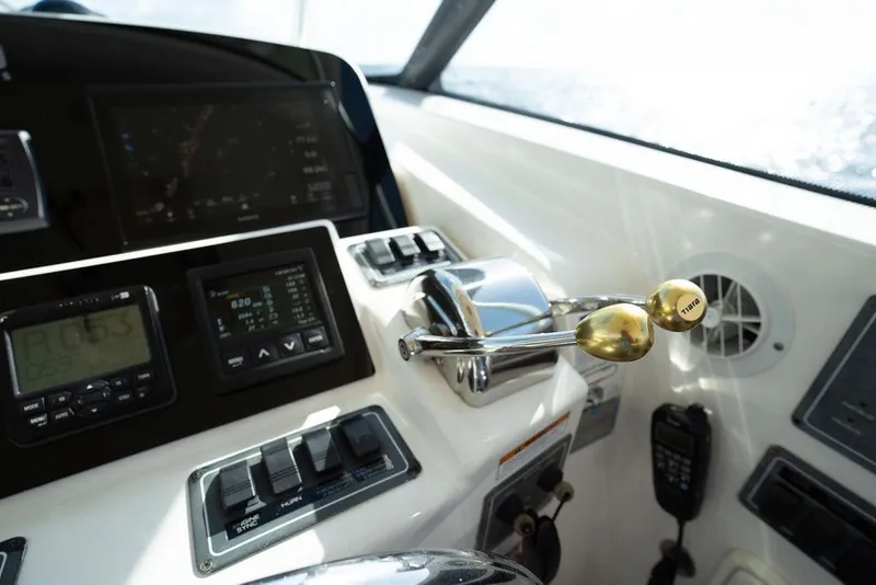 Slide: The Image of Control panel of a 2005 Tiara Yachts 4200 Open, featuring navigation and throttle controls. - 40
