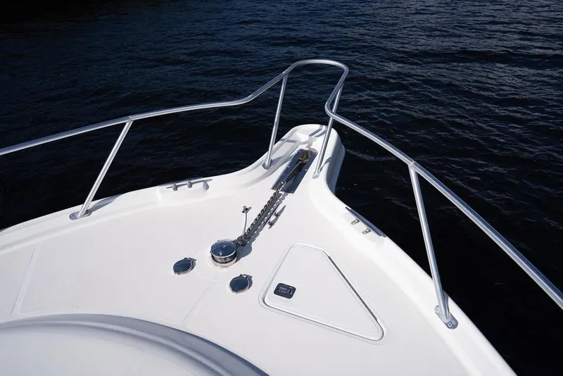 Slide: The Image of Bow of 2005 Tiara Yachts 4200 Open, featuring sleek railings and anchor system. - 41