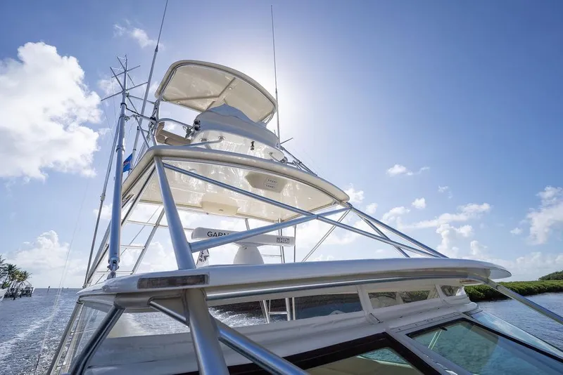 Slide: The Image of 2005 Tiara Yachts 4200 Open under clear blue sky, showcasing sleek design. - 45