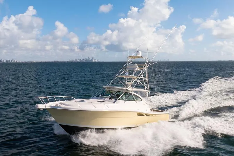 Slide: The Image of 2005 Tiara Yachts 4200 Open cruising on open water under a blue sky. - 5