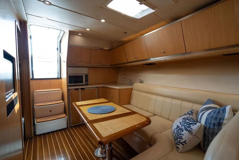 Slide: The Image of Luxurious interior of 2005 Tiara Yachts 4200 Open with elegant seating and wooden cabinetry. - 51