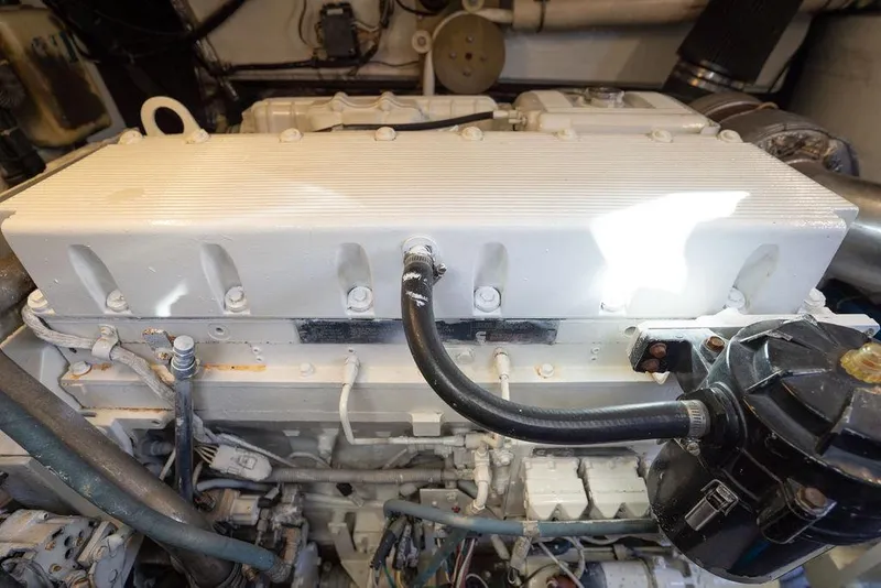 Slide: The Image of Engine compartment of a 2005 Tiara Yachts 4200 Open, showcasing mechanical components and hoses. - 59