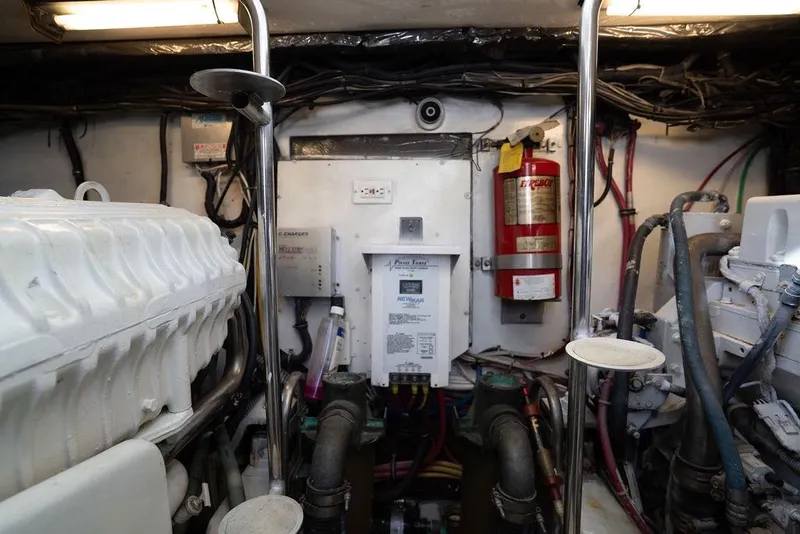 Slide: The Image of Engine room of a 2005 Tiara Yachts 4200 Open, featuring equipment and fire extinguisher. - 60