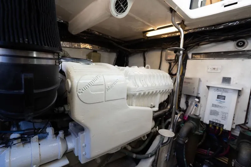 Slide: The Image of Engine room of a 2005 Tiara Yachts 4200 Open, featuring a Cummins Marine engine. - 61