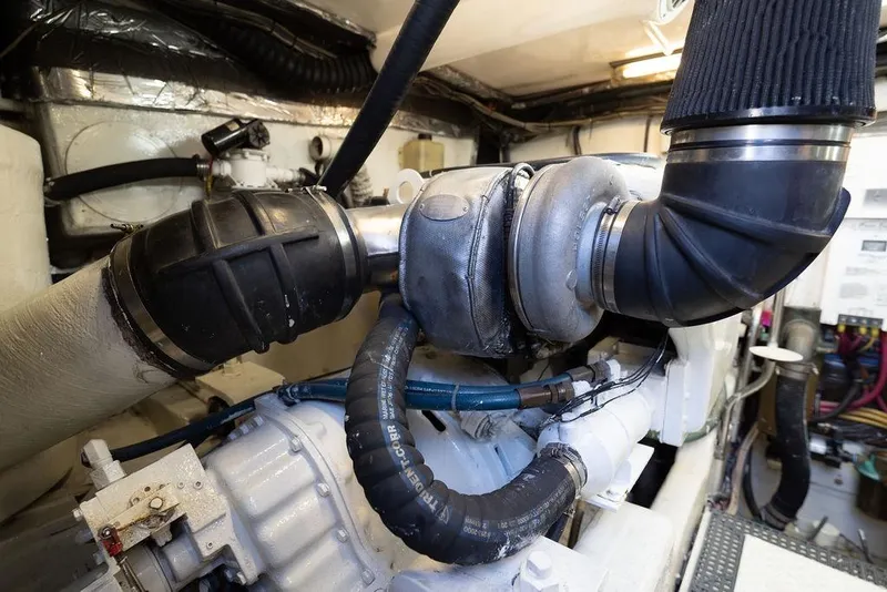 Slide: The Image of Engine room of 2005 Tiara Yachts 4200 Open, showcasing mechanical components and piping. - 62