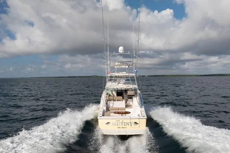 Slide: The Image of 2005 Tiara Yachts 4200 Open cruising on open water under cloudy skies. - 8